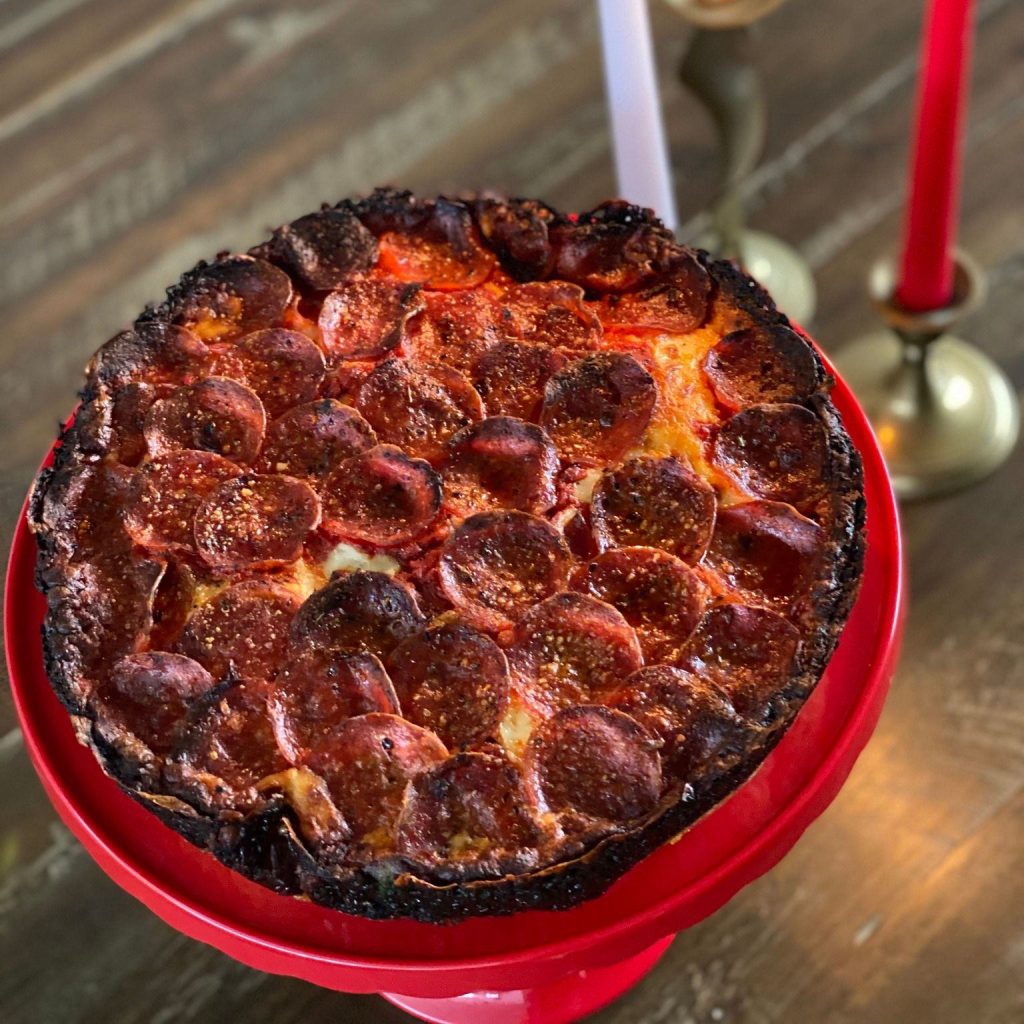 A pizza on a plate
Description automatically generated