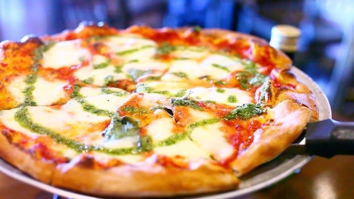 A pizza on a plate
Description automatically generated