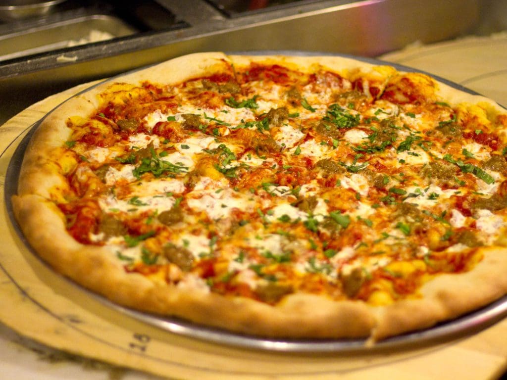 A pizza on a tray
Description automatically generated