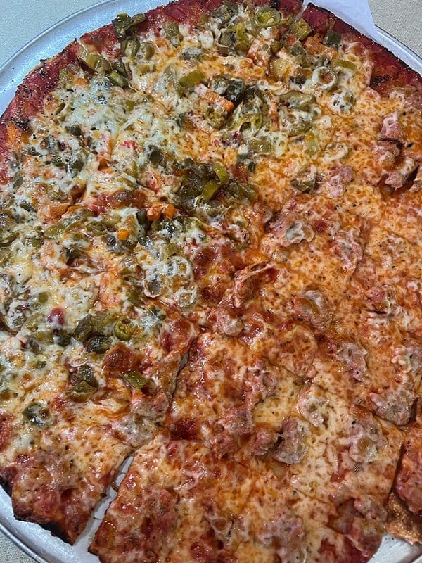 A pizza with jalapenos on it
Description automatically generated