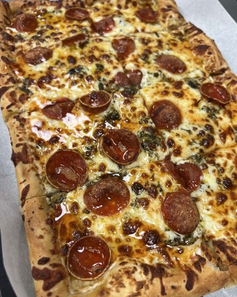 A pizza with pepperoni on top
Description automatically generated